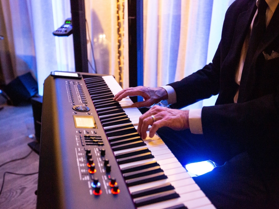 A man playing the piano with a jazz band. 
