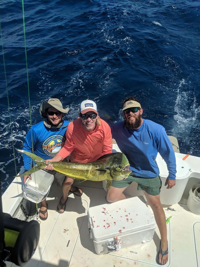 Men posing with a large fish 