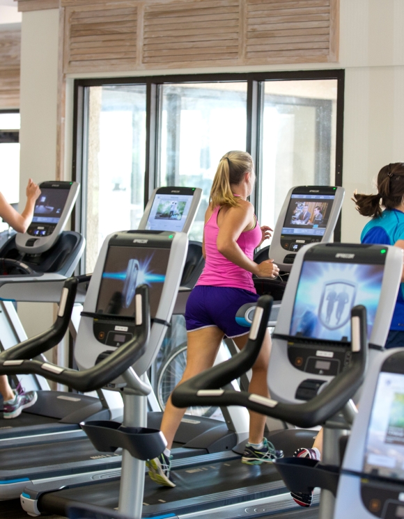 People running on treadmills in the fitness centre 