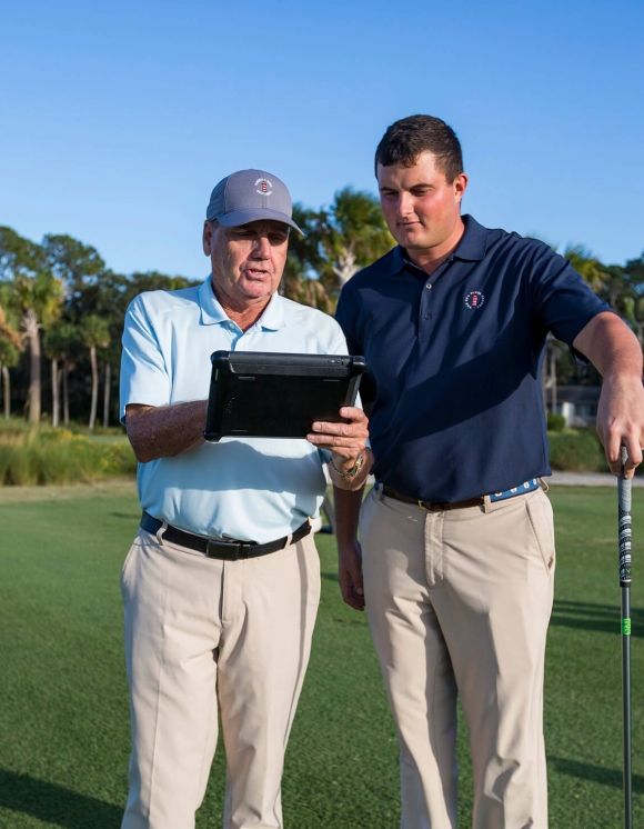 Two men discussing on a golf course 