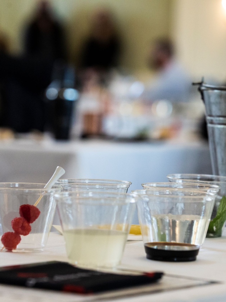 Ingredients for a cocktail in separate cups for a mixology class.