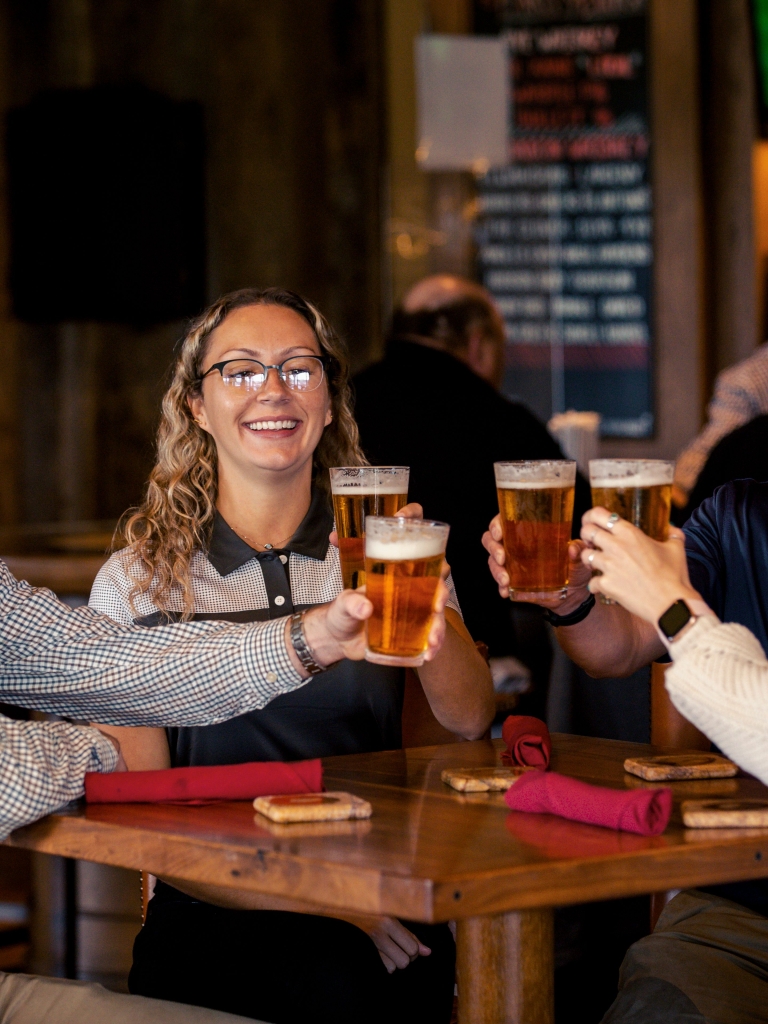 People cheer-sing with beer at Fraser's Restaurant 