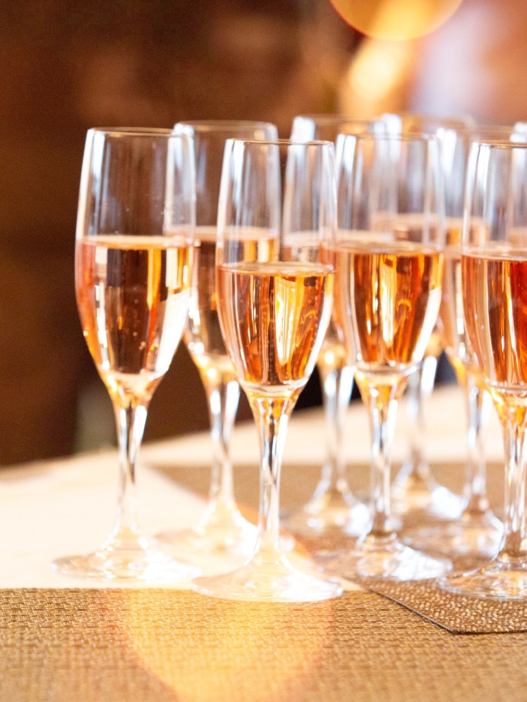 A group of champagne glasses on a table. 